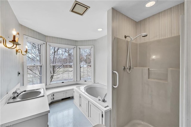 bathroom featuring separate shower and tub and vanity