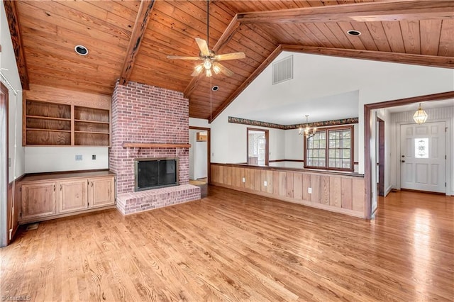 unfurnished living room with light hardwood / wood-style floors, wooden ceiling, ceiling fan with notable chandelier, and a brick fireplace