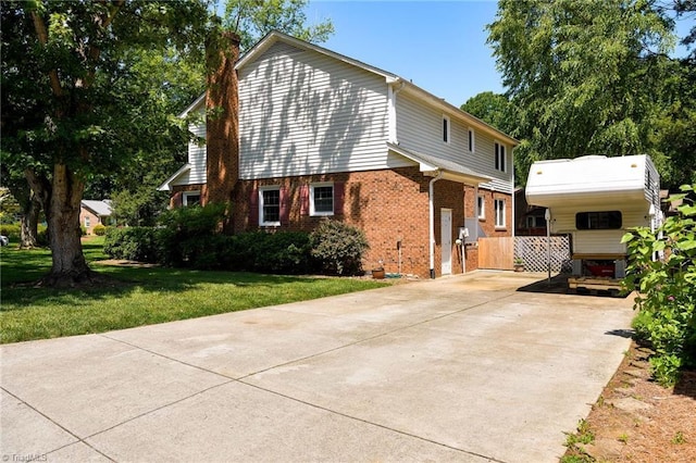 3600 Spicebush Trl, Greensboro, NC 27410 - view of front of home with driveway, a chimney, brick siding, and a front lawn