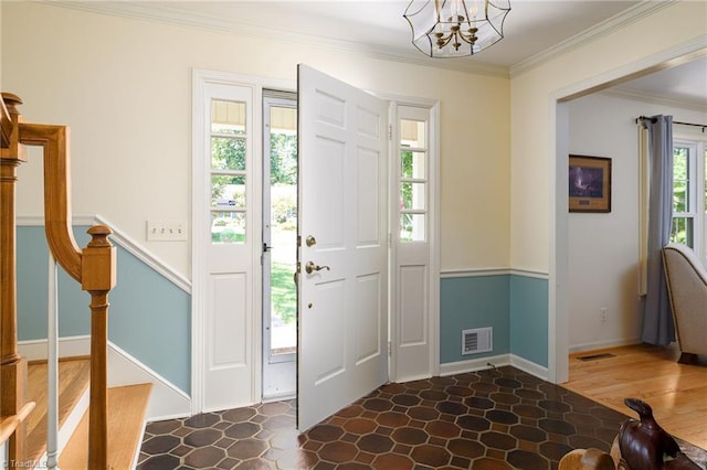 3600 Spicebush Trl, Greensboro, NC 27410 - foyer featuring crown molding, a chandelier, and stairway