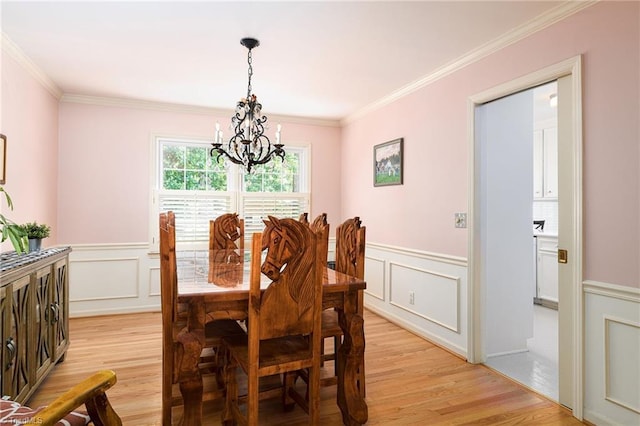 3600 Spicebush Trl, Greensboro, NC 27410 - dining space with a chandelier, light wood finished floors, ornamental molding, a decorative wall, and wainscoting