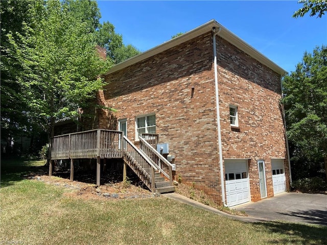 view of property exterior featuring a deck, a garage, and a lawn