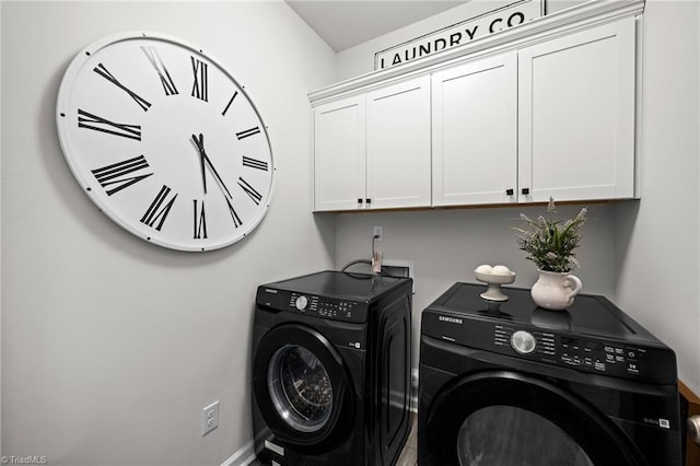 laundry room featuring separate washer and dryer, cabinet space, and baseboards