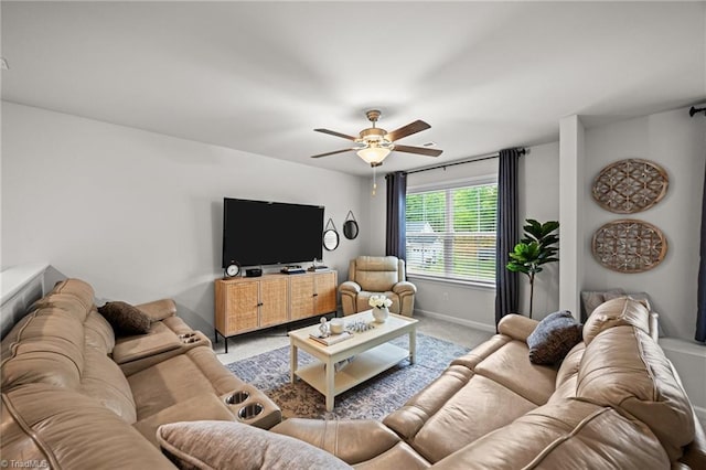 living room with baseboards, carpet flooring, and a ceiling fan