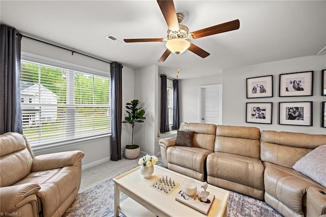 living area with baseboards, ceiling fan, carpet, and visible vents