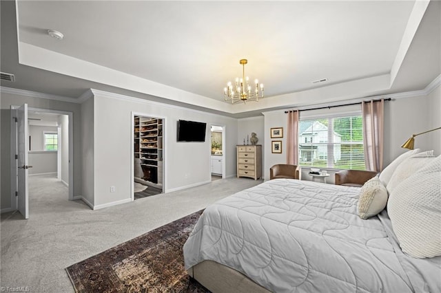 carpeted bedroom featuring crown molding, a tray ceiling, a notable chandelier, and baseboards