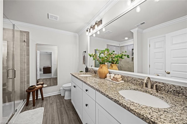 bathroom with visible vents, a sink, and wood finished floors