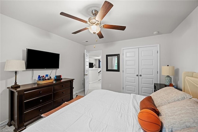 bedroom with baseboards, ceiling fan, and a closet