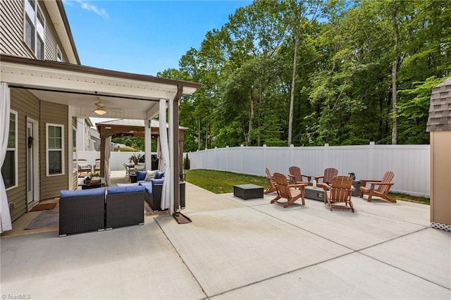 view of patio / terrace with a fenced backyard and an outdoor living space with a fire pit