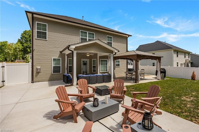 back of property with a gazebo, a fenced backyard, a patio area, and an outdoor living space with a fire pit