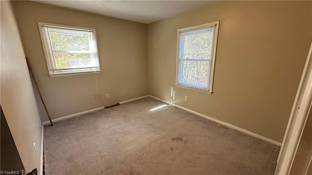 carpeted empty room with plenty of natural light