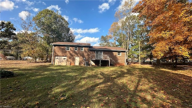 rear view of house featuring a yard and central air condition unit