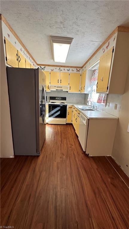 kitchen featuring dark hardwood / wood-style floors, a textured ceiling, sink, and white appliances