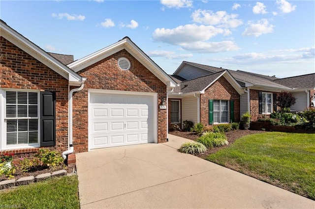 ranch-style home featuring driveway, brick siding, a front lawn, and an attached garage