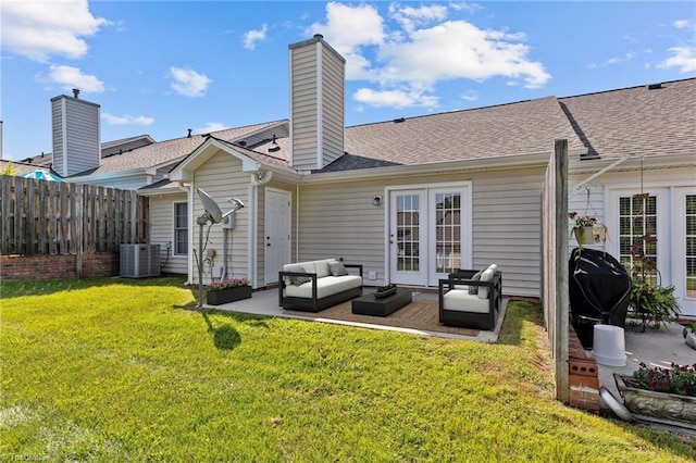 back of house featuring a patio, a lawn, central AC unit, fence, and an outdoor living space