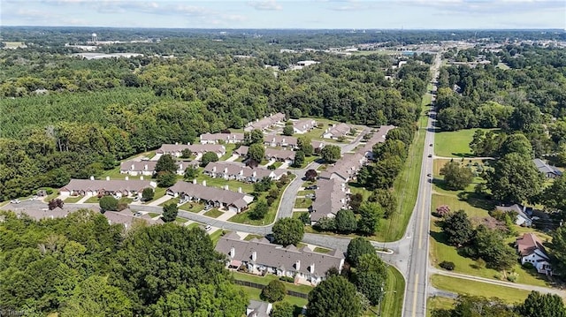 birds eye view of property featuring a forest view and a residential view