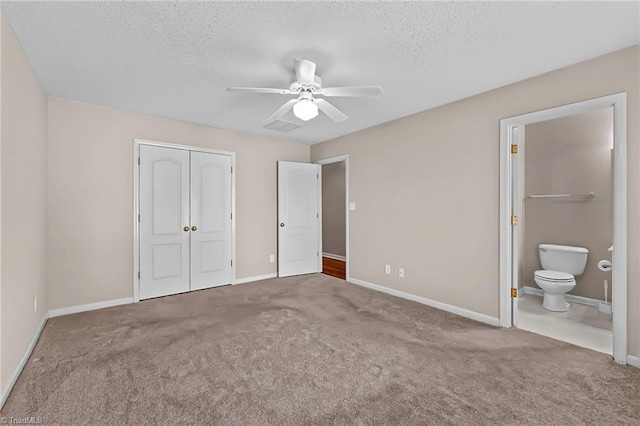 unfurnished bedroom with carpet floors, a closet, a textured ceiling, and baseboards