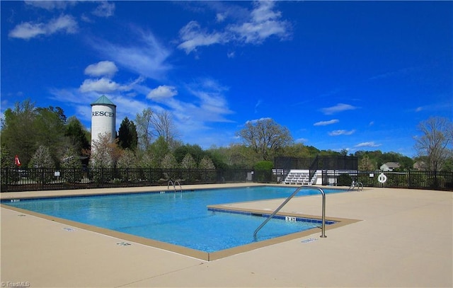 pool featuring a patio area and fence