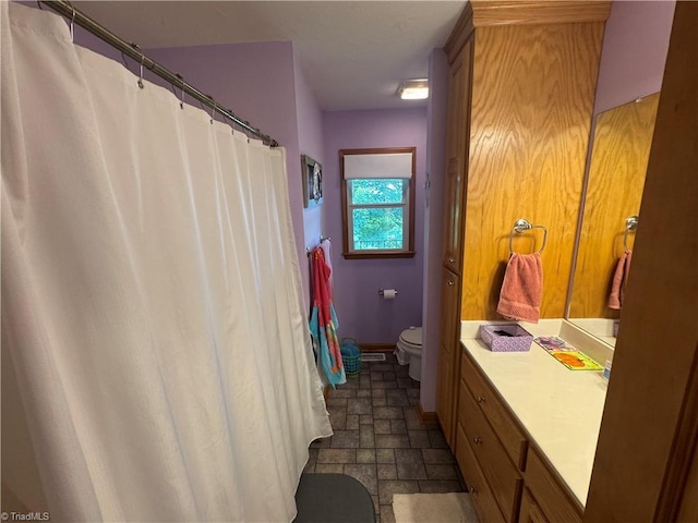 1346 Overland Trl, Hays, NC 28635 - full bathroom featuring toilet, stone finish floors, vanity, and baseboards
