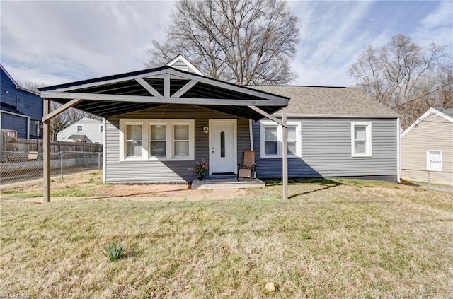 bungalow-style house featuring a front yard, roof with shingles, and fence