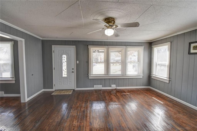 foyer entrance featuring a wealth of natural light, visible vents, and hardwood / wood-style flooring