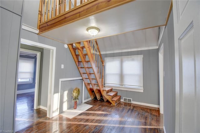 interior space featuring stairs, wood finished floors, visible vents, and baseboards