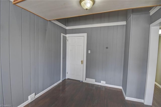 interior space featuring wood finished floors and baseboards