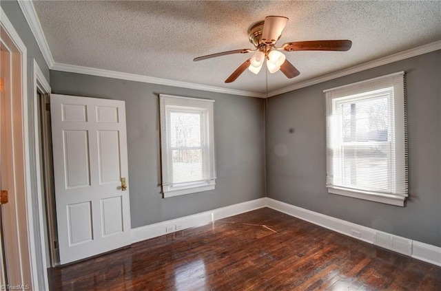 unfurnished room with dark wood-style floors, ornamental molding, a textured ceiling, and baseboards