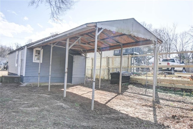 view of parking featuring a carport and fence