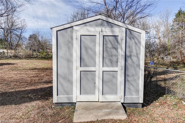 view of shed featuring fence