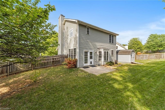 900 Biloxi Ave, Kernersville, NC 27284 - rear view of property featuring a patio area, a storage unit, a fenced backyard, a chimney, and a lawn