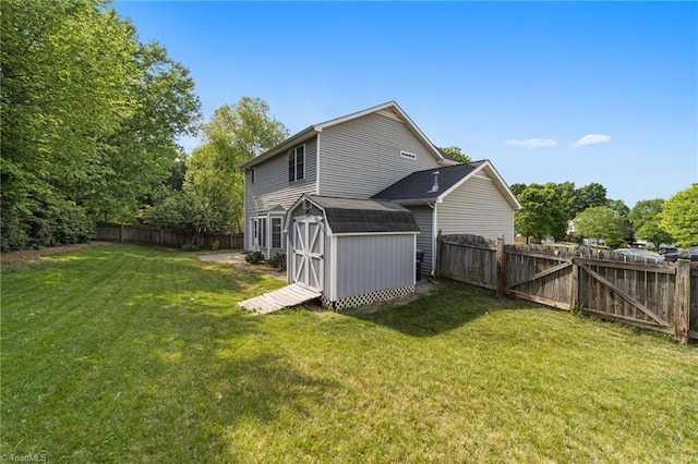 900 Biloxi Ave, Kernersville, NC 27284 - back of house with a yard, an outdoor structure, a fenced backyard, and a storage unit