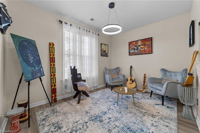 900 Biloxi Ave, Kernersville, NC 27284 - living area with baseboards, visible vents, and wood finished floors