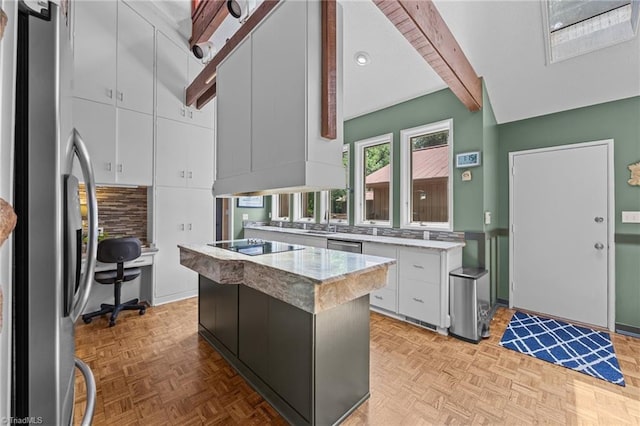 3715 Bentbrook Dr, High Point, NC 27265 - kitchen featuring stainless steel appliances, white cabinetry, decorative backsplash, a kitchen island, and beam ceiling