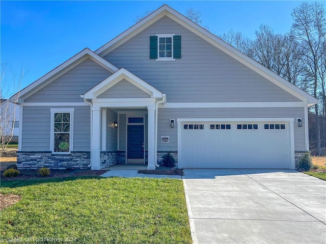 view of front of property with a garage, stone siding, concrete driveway, and a front yard