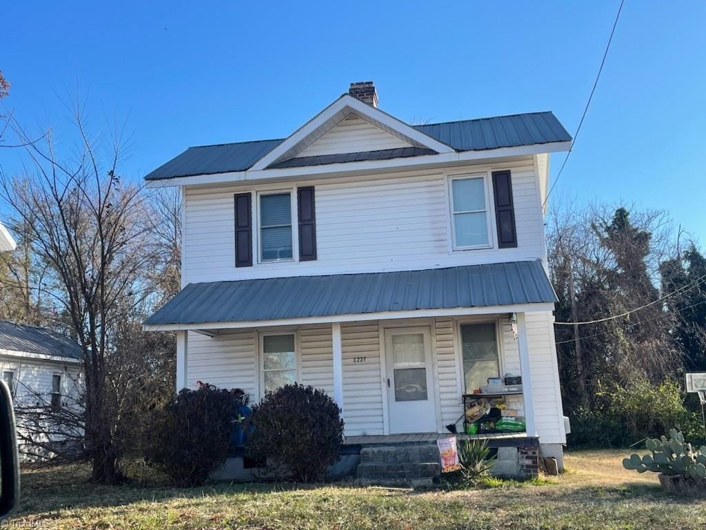 view of front of home featuring covered porch and a front yard