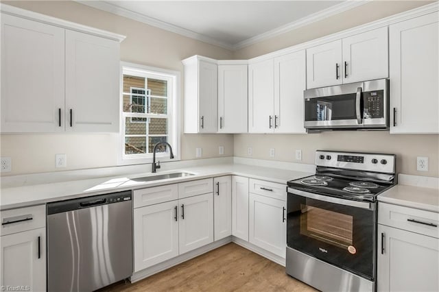 kitchen featuring white cabinets, stainless steel appliances, and light countertops