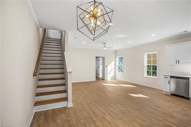 unfurnished living room featuring ornamental molding, light wood-style flooring, stairway, and baseboards