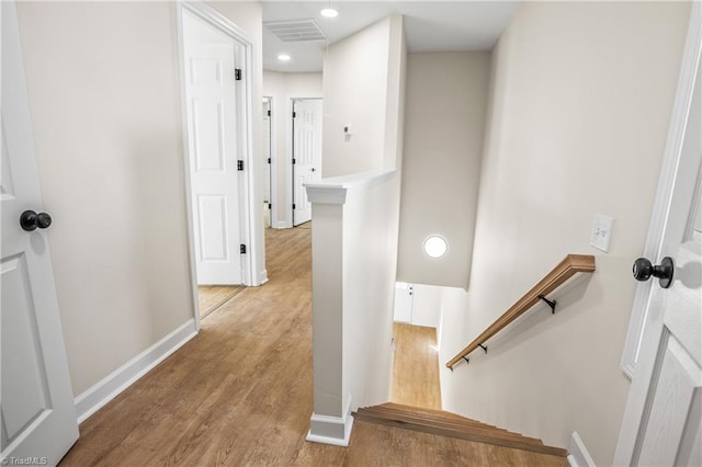 stairs featuring recessed lighting, visible vents, baseboards, and wood finished floors