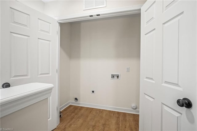 laundry area featuring laundry area, washer hookup, visible vents, light wood-type flooring, and electric dryer hookup