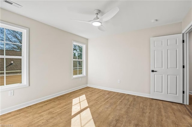 unfurnished bedroom with baseboards, visible vents, ceiling fan, and light wood finished floors