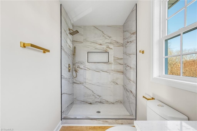 full bathroom with toilet and a marble finish shower