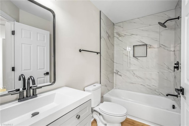 full bathroom featuring tub / shower combination, vanity, and toilet