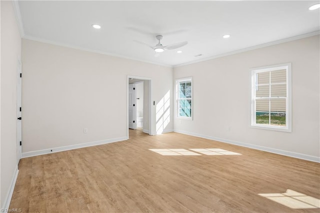 spare room with ornamental molding, recessed lighting, light wood-style flooring, and baseboards