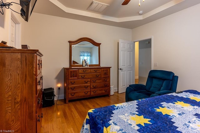 4036 Eastside Ct, Winston-Salem, NC 27127 - bedroom featuring wood finished floors, a ceiling fan, baseboards, and a raised ceiling