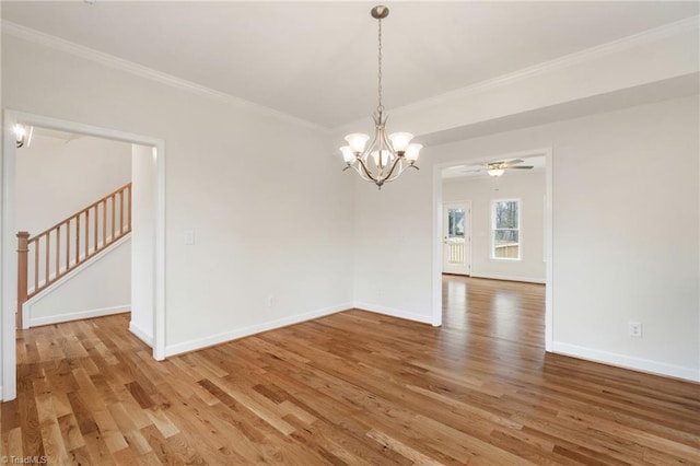 spare room featuring stairway, light wood-type flooring, baseboards, and ornamental molding