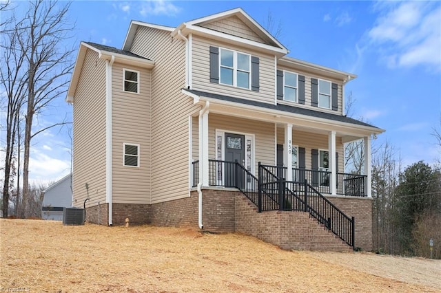 view of front facade with stairs, covered porch, and central AC