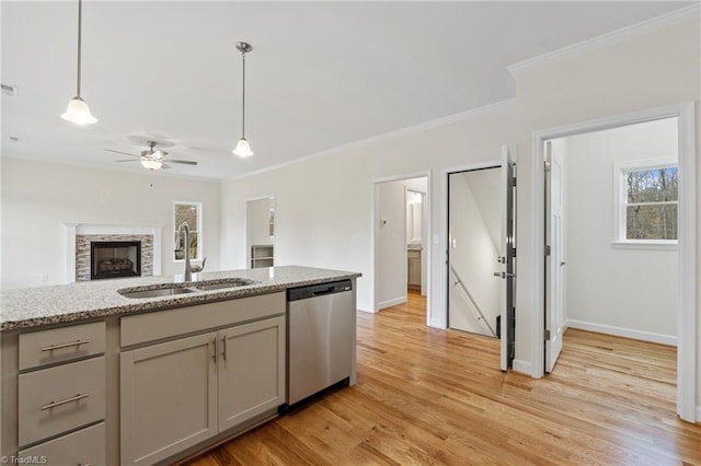 kitchen featuring light wood-type flooring, gray cabinetry, pendant lighting, a sink, and dishwasher