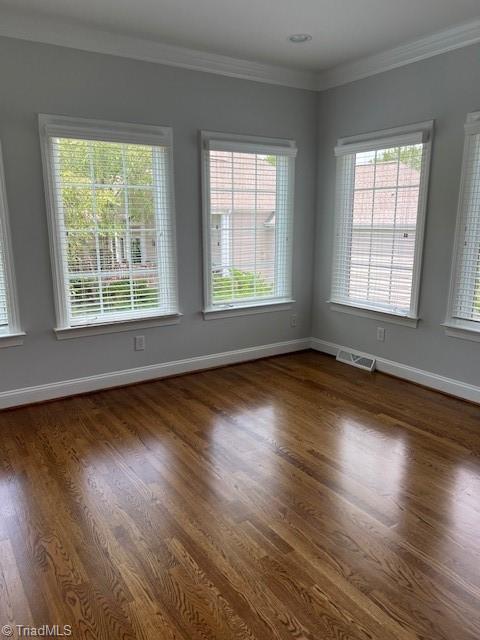 375 Hollybrook Dr, Bermuda Run, NC 27006 - empty room with dark wood-style flooring and crown molding