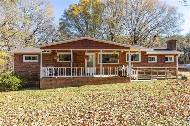 single story home with covered porch and a front lawn